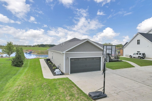 view of front facade with a garage, a water view, and a front lawn