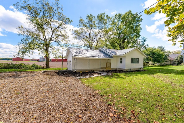 rear view of property with a yard