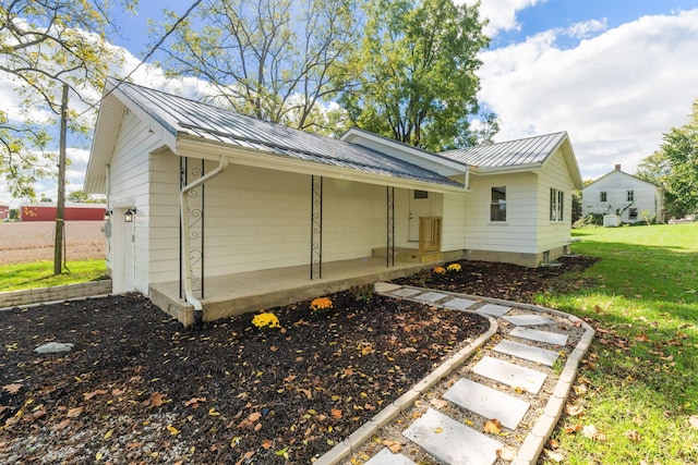 rear view of property with a lawn