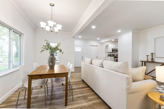 living room featuring ornamental molding, light hardwood / wood-style floors, and a notable chandelier