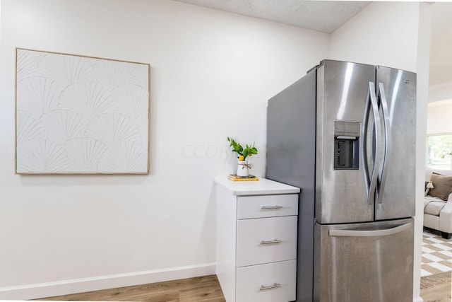 kitchen featuring light hardwood / wood-style floors and stainless steel fridge with ice dispenser