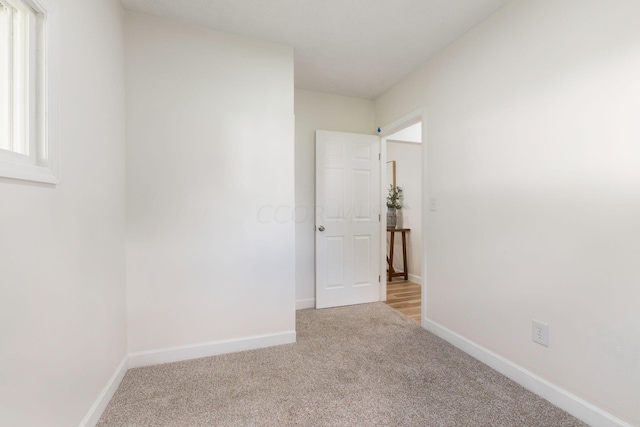 empty room featuring light carpet