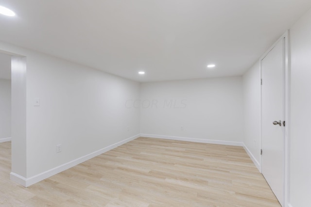 basement with light hardwood / wood-style flooring