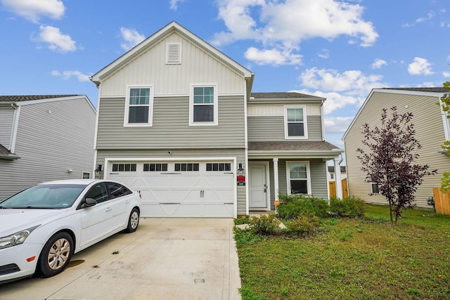 view of front of home with a front lawn and a garage