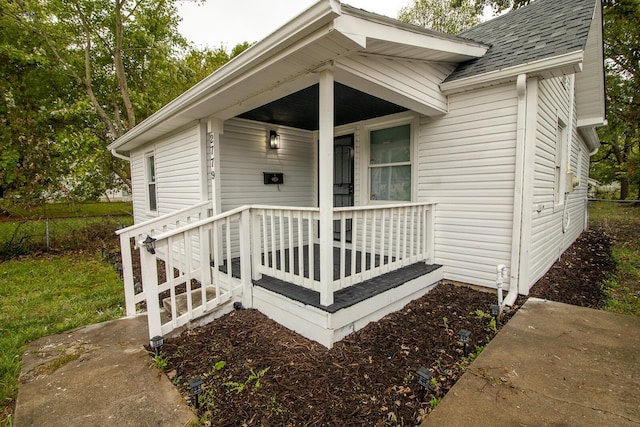 view of exterior entry featuring covered porch