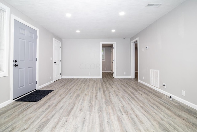 empty room with light hardwood / wood-style flooring