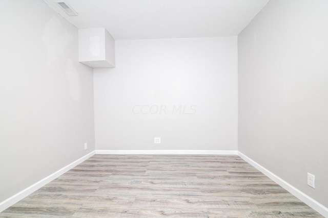 spare room with light hardwood / wood-style flooring