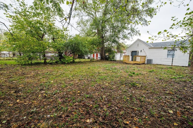 view of yard featuring a deck and central air condition unit