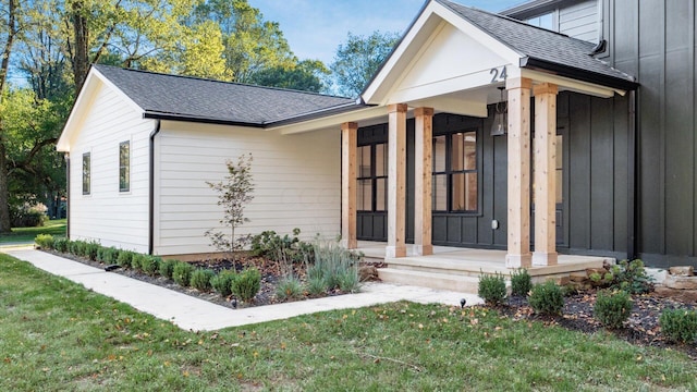 property entrance with a lawn