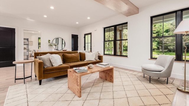 living room featuring beam ceiling and light hardwood / wood-style flooring