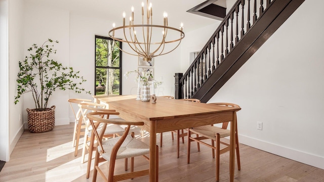 dining space featuring a chandelier and light wood-type flooring