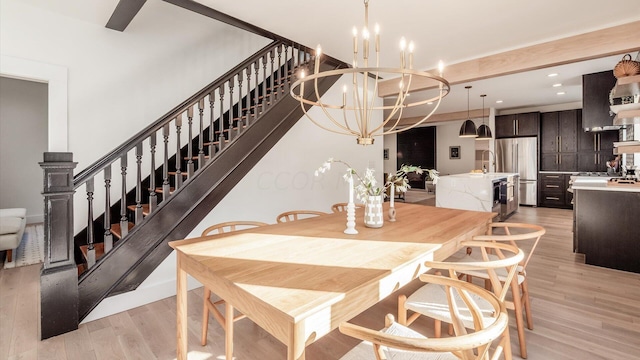 dining room with light hardwood / wood-style flooring and a notable chandelier