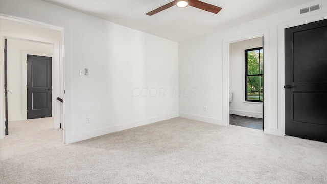 unfurnished room with ceiling fan and light carpet