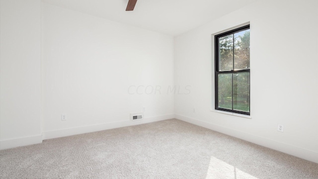 carpeted empty room featuring ceiling fan