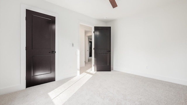 unfurnished bedroom with ceiling fan and light carpet