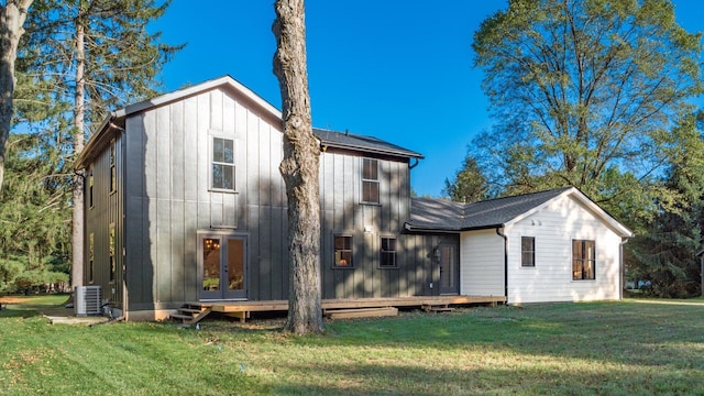 rear view of property with french doors, a yard, and central air condition unit