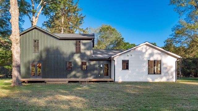 rear view of property featuring a yard