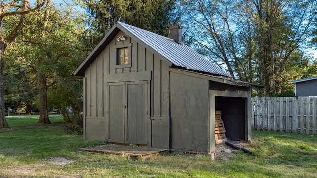 view of outdoor structure featuring a lawn