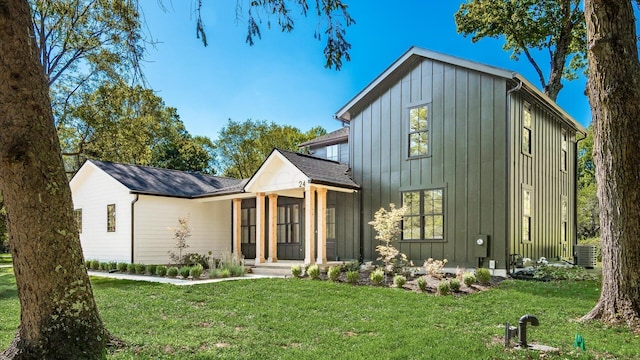 modern farmhouse featuring a front lawn and central AC unit