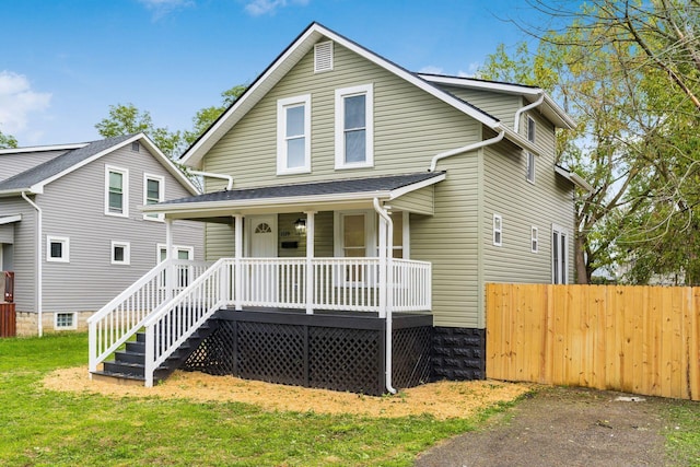 view of front of home featuring covered porch and a front yard