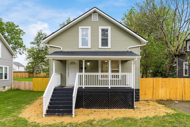 bungalow-style house with covered porch and a front lawn