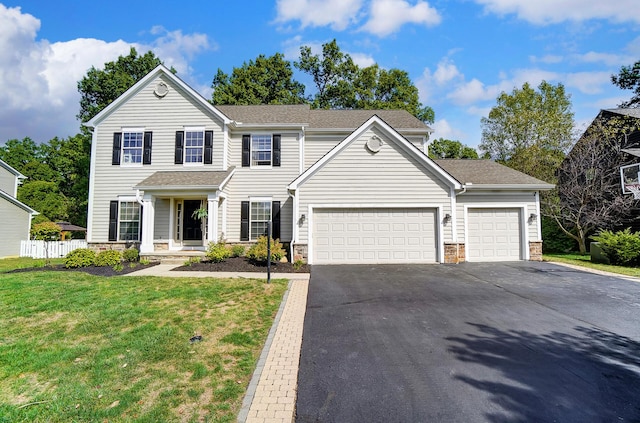 view of front of house featuring a front yard and a garage