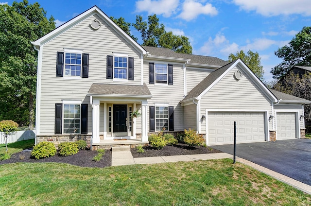 view of front of home featuring a garage and a front lawn