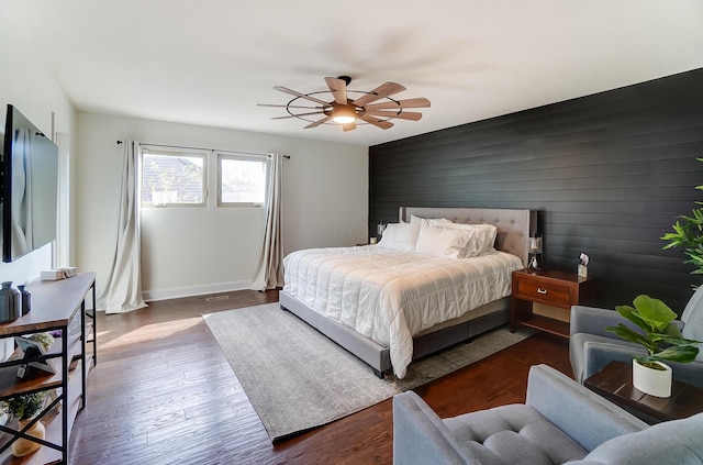 bedroom featuring dark hardwood / wood-style flooring and ceiling fan