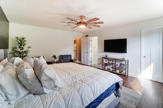 bedroom with ceiling fan and dark hardwood / wood-style flooring