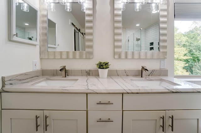 bathroom with vanity and a shower with door