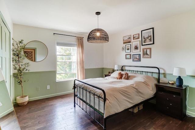 bedroom with dark hardwood / wood-style floors