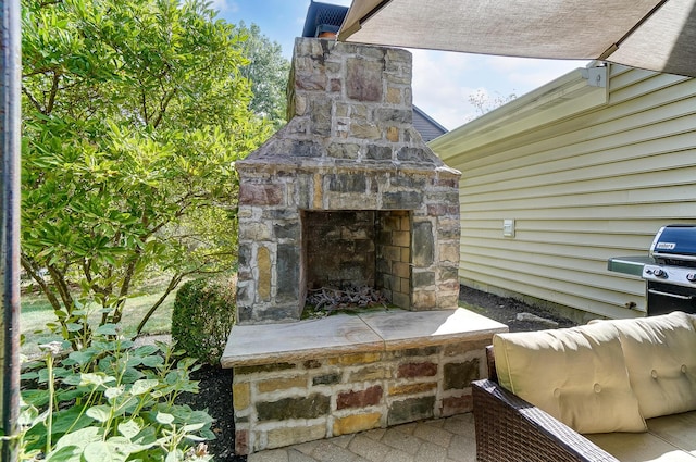 view of patio / terrace featuring an outdoor stone fireplace