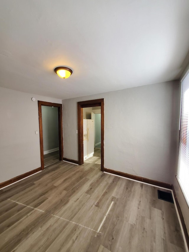 unfurnished room featuring hardwood / wood-style floors