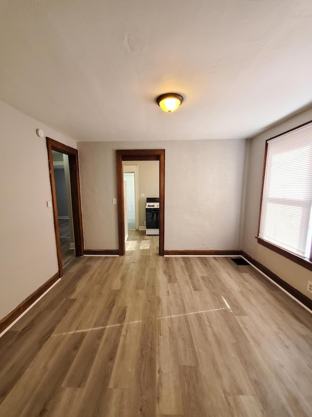 unfurnished room with light wood-type flooring