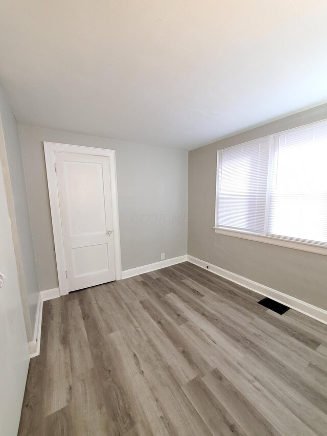 spare room featuring hardwood / wood-style flooring