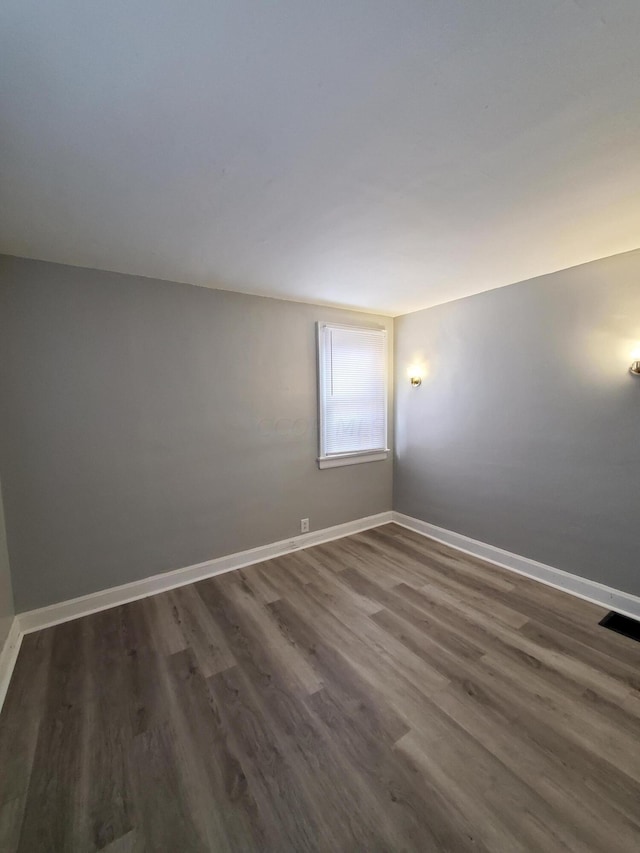 unfurnished room featuring dark hardwood / wood-style floors