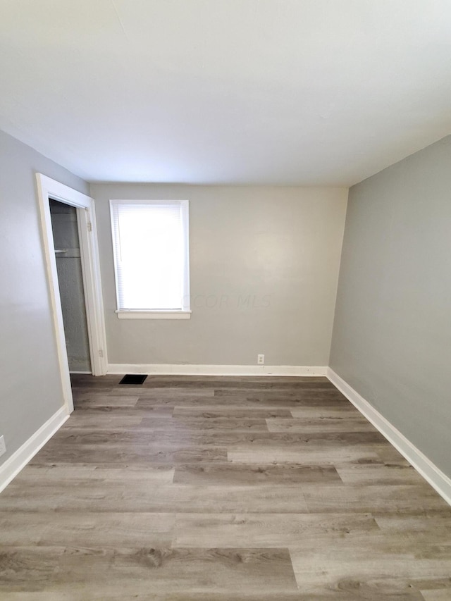 unfurnished bedroom featuring light wood-type flooring and a closet