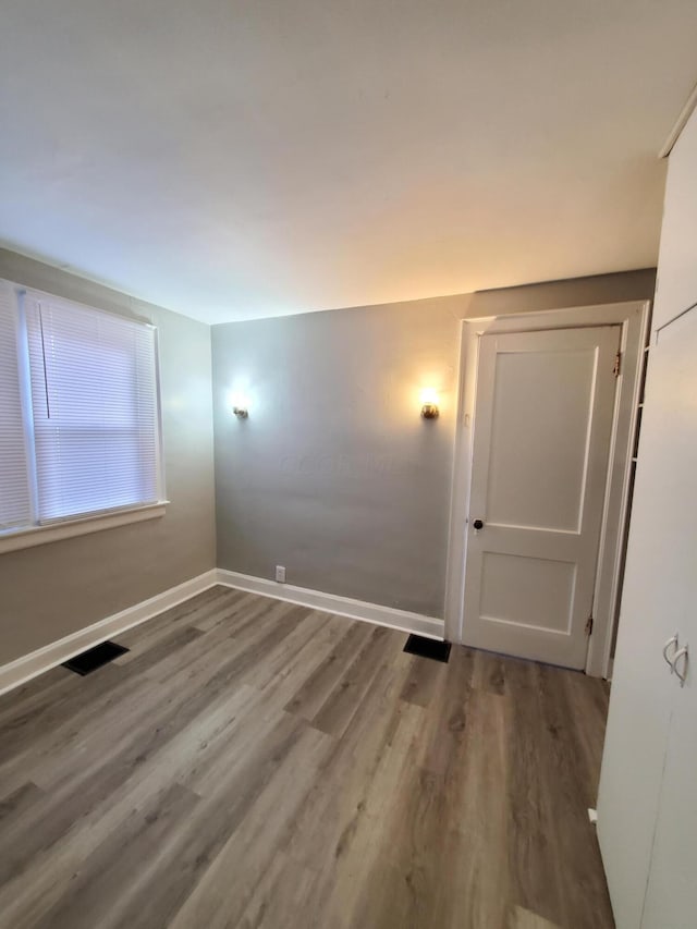 empty room with hardwood / wood-style flooring