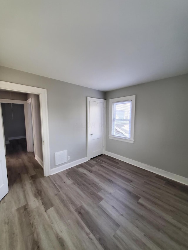 unfurnished room featuring hardwood / wood-style flooring