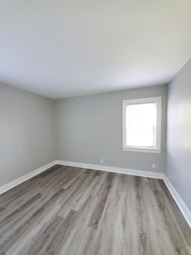 spare room featuring light hardwood / wood-style floors