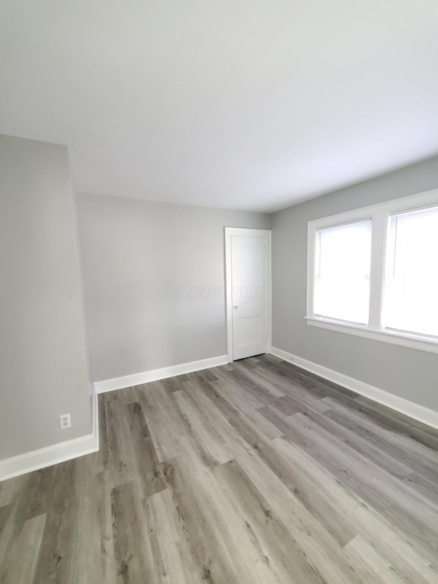 empty room with light hardwood / wood-style flooring