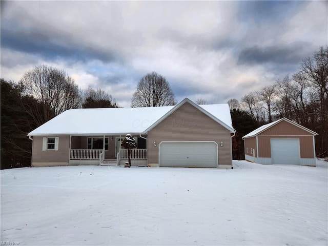 ranch-style home with an outbuilding, a porch, and a garage