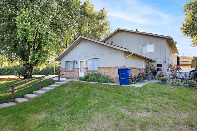 view of home's exterior with a yard