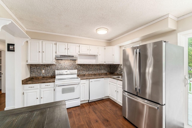 kitchen with white appliances, dark wood-type flooring, ornamental molding, tasteful backsplash, and white cabinetry