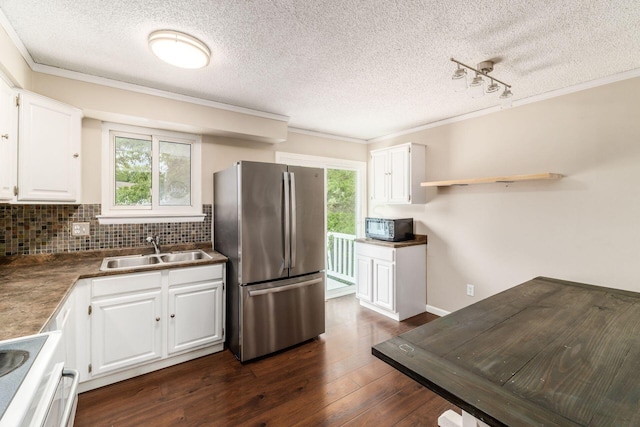 kitchen featuring stove, white cabinets, sink, dark hardwood / wood-style flooring, and stainless steel refrigerator