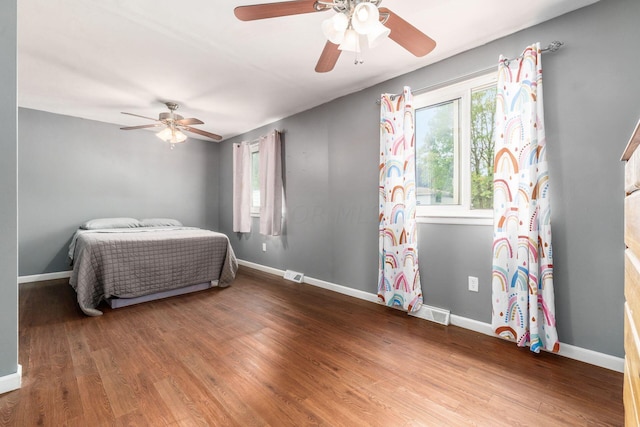 bedroom with hardwood / wood-style floors and ceiling fan