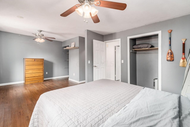 bedroom with a closet, ceiling fan, and dark hardwood / wood-style flooring