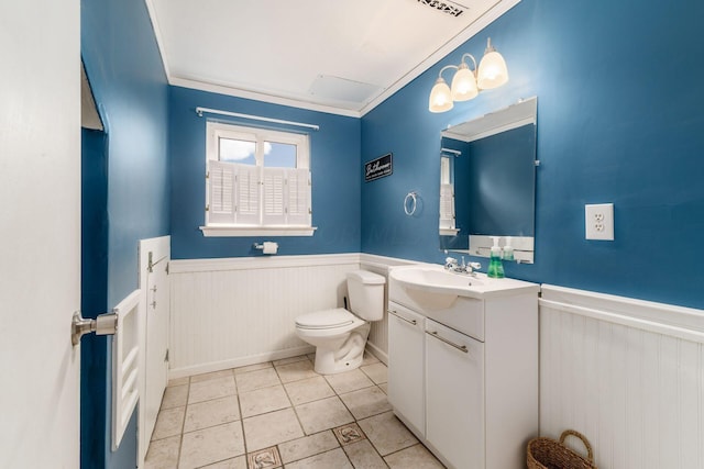 bathroom featuring tile patterned flooring, vanity, toilet, and ornamental molding