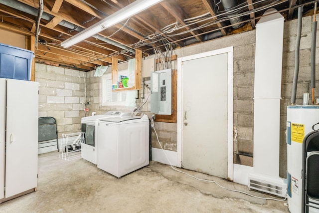 basement featuring white refrigerator, independent washer and dryer, electric panel, and water heater