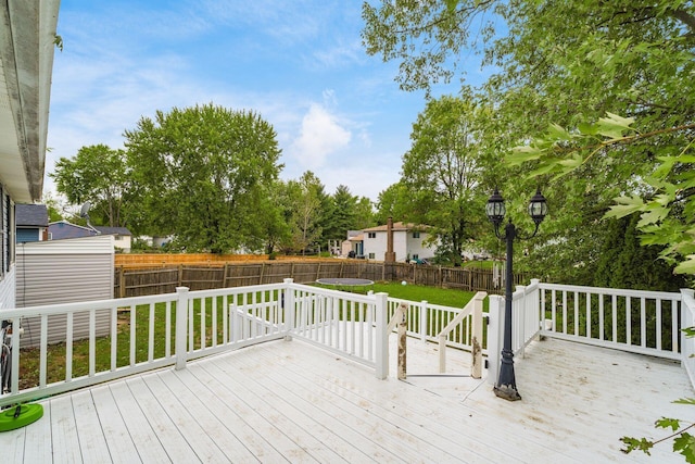 wooden terrace featuring a lawn